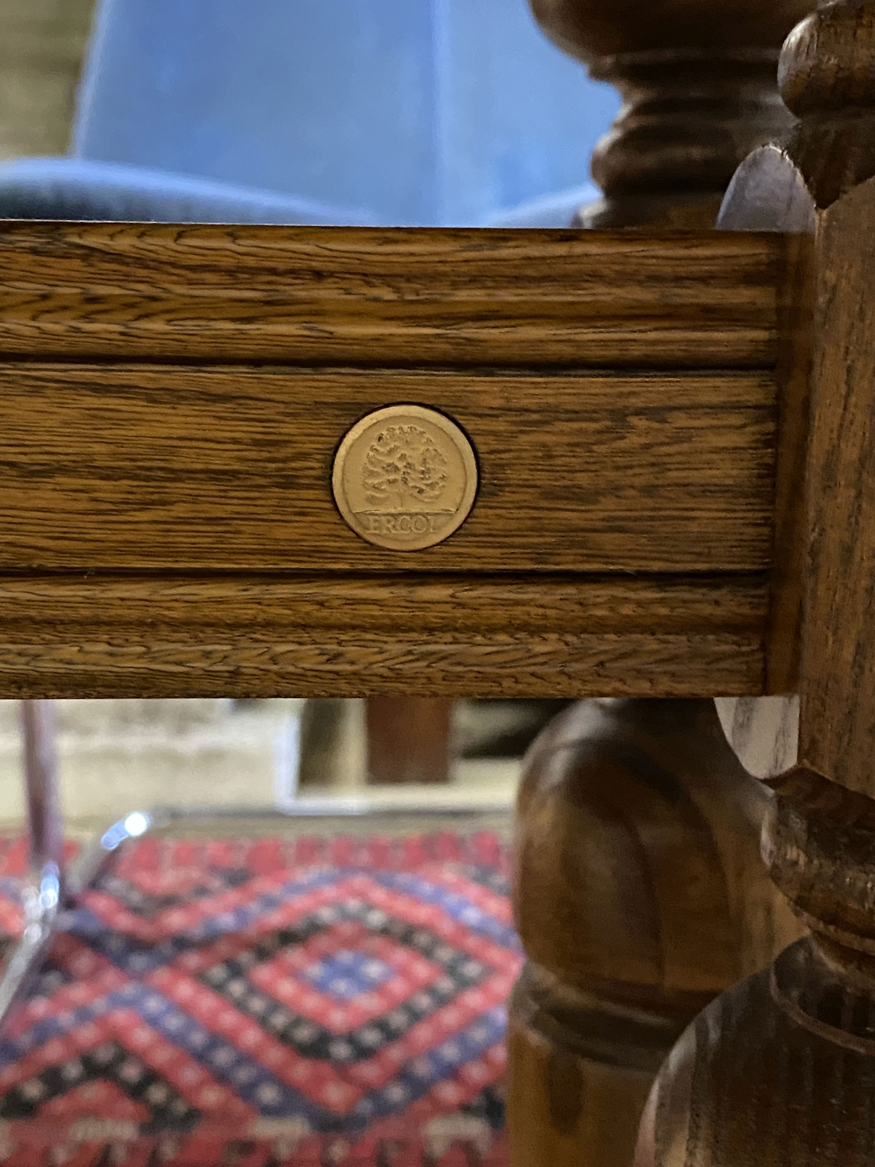 An Ercol Golden Dawn elm extending dining table, length 250cm extended (three spare leaves), width 100cm, height 74cm